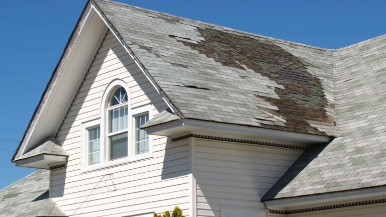 Deteriorating roof shingles on a residential home showing signs of premature roof failure